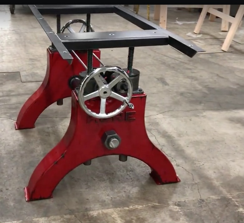 A red Crank Hure table base with chrome Crank