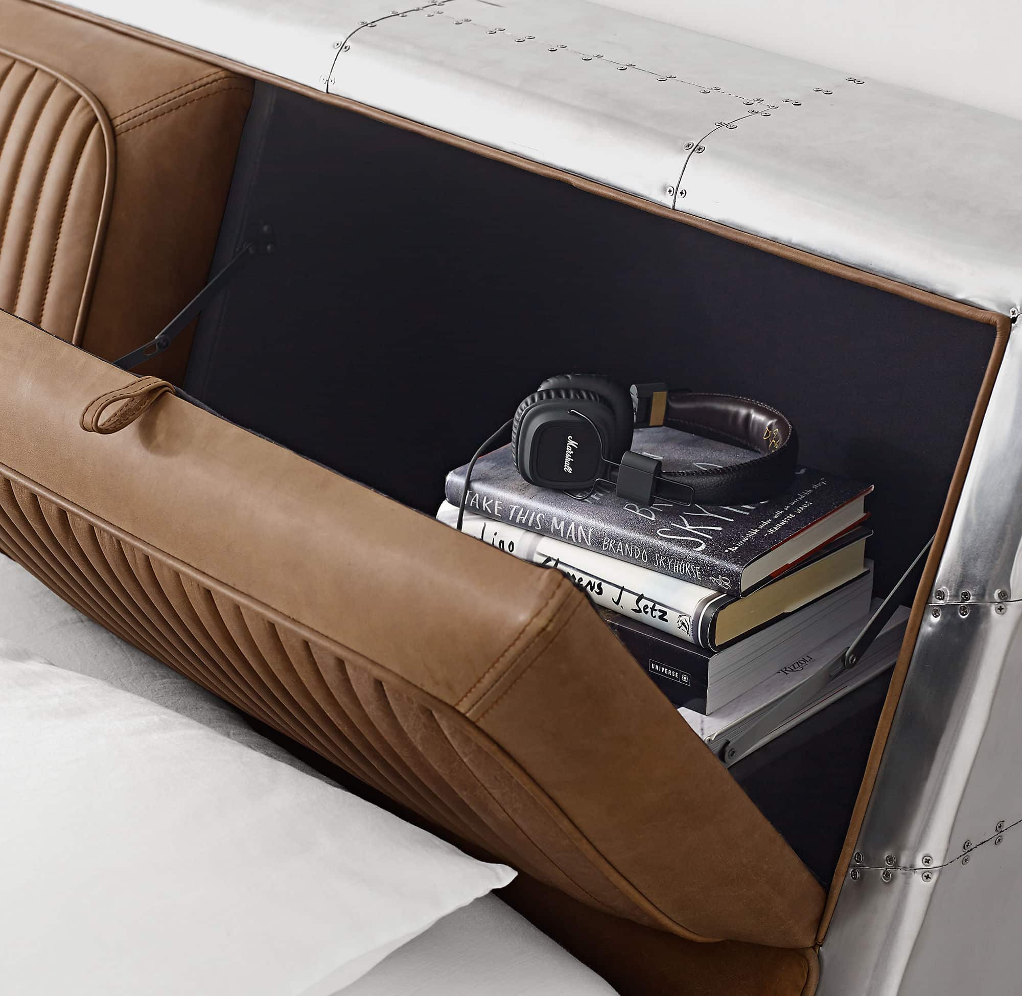 An sexy Aviator bed with a leather headboard to store your belongings.